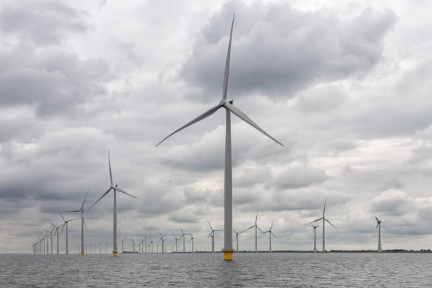 istock Offshore windfarm near Dutch coast with cloudy sky 873332704