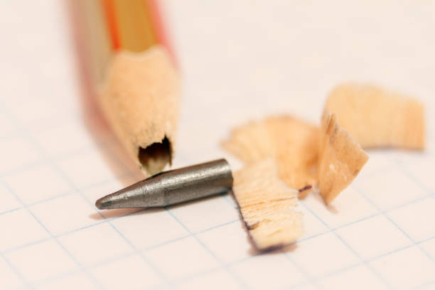 istock Sharpened pencil with a broken tip over a blank sheet of paper 873332818