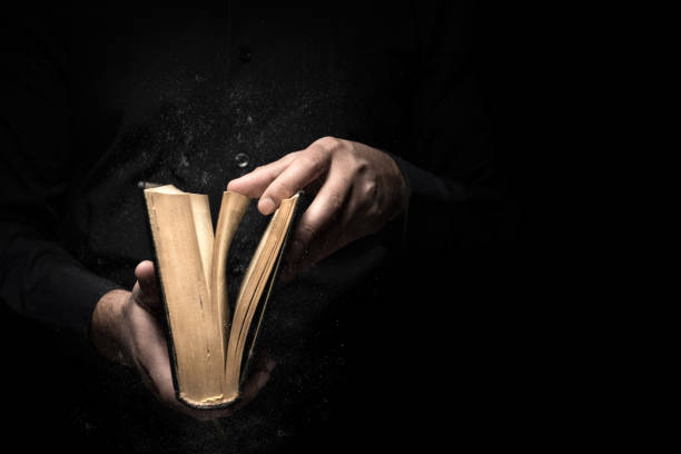 Man reads a book Man reads a book high quality and high resolution studio shoot bible open stock pictures, royalty-free photos & images