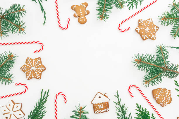 istock Round made of gingerbread, winter tree and candy cane on white background. Flat lay. top view. Christmas or New year concept 873333910