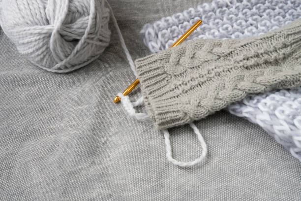 istock gray yarn and golden crochet hook for crocheting clothes 873337848