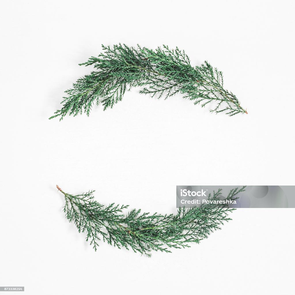 Christmas wreath made of cypress branches. Flat lay, top view Christmas wreath made of cypress branches on white background. Christmas, winter concept. Flat lay, top view, copy space, square Christmas Stock Photo