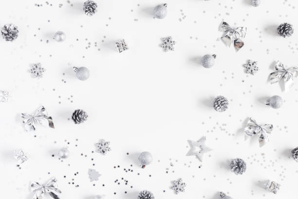 istock Christmas silver decorations on white background. Flat lay, top view 873339210