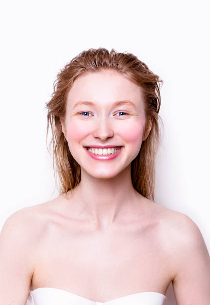 Beautiful young woman smiling looks very happy and excited Beautiful young woman with pale white skin rose color blush cheeks and pink lipstick Looking fresh and lovely Fashion model close-up studio portrait Exstraordinaly elf and princess - like beauty Happy excited smile laugh rosy cheeks stock pictures, royalty-free photos & images