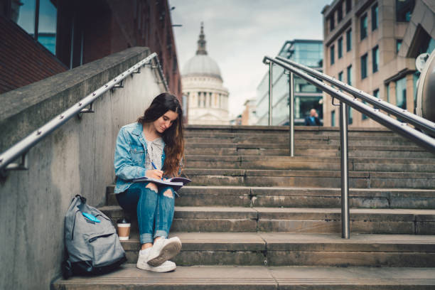 istock Schoolgirl in UK studying outside 873340850