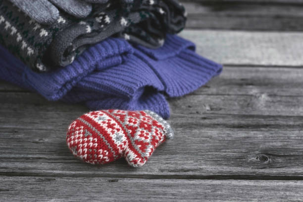 istock A Stack of Cozy Knitted Sweaters, Scarves, Gloves. Woolen Things for Christmas. 873341536