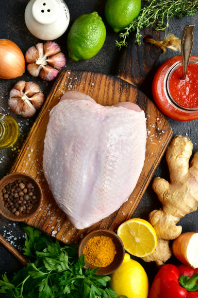 istock Raw organic chicken breast with ingredients for making 873359194