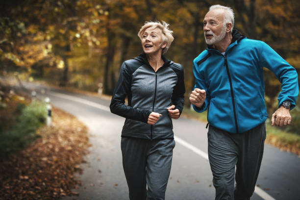 istock Senior couple jogging in a forest. 873362498