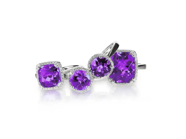 Set of purple amethyst ametrine rings gemstone fine jewelry. Group stack or cluster of multiple gemstone diamond rings.