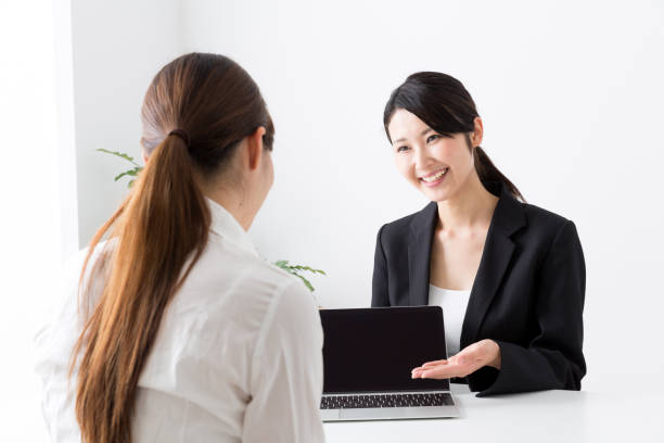 asian businesswoman talking in office asian businesswoman talking in office talking two people business talk business stock pictures, royalty-free photos & images