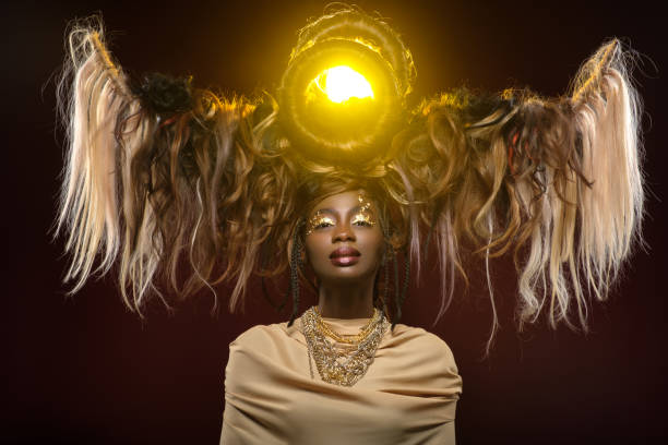 beautiful girl with art hair composition beautiful black young woman with art hair composition and gold makeup. golden goddess.  beauty studio shot on dark background. copy space. goddess photos stock pictures, royalty-free photos & images