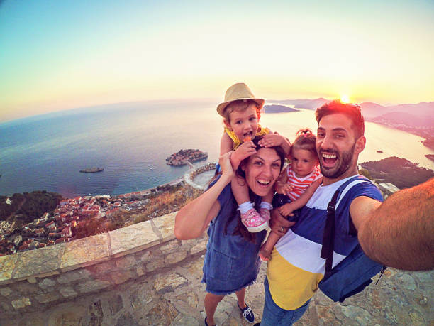 family with two little daughters travel in nature, making selfie, smiling - family tourist europe vacations imagens e fotografias de stock