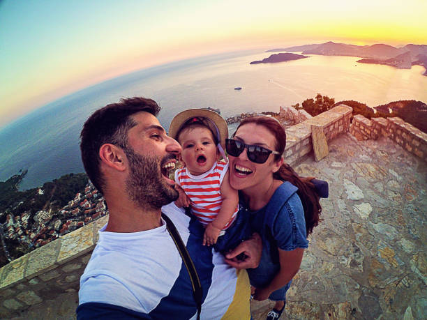 istock Family with small daughter making selfie while travel 873385254