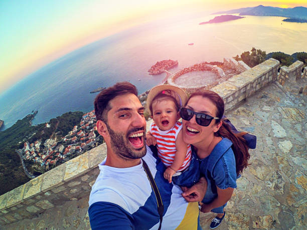 istock Family with small daughter making selfie while travel 873385544