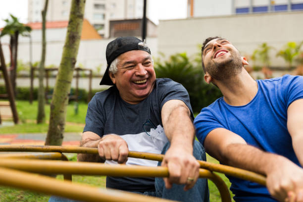 istock Dad and son playing on roundabout 873386060
