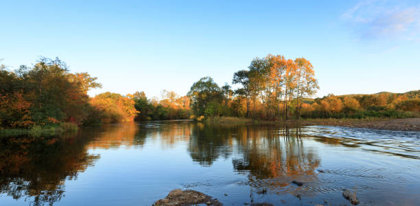 istock sunrise over river and autumn forest 873386180
