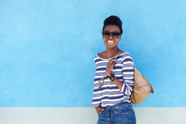 istock cool young woman smiling with handbag 873393094