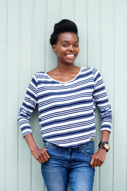 istock smiling black woman with striped shirt 873393160