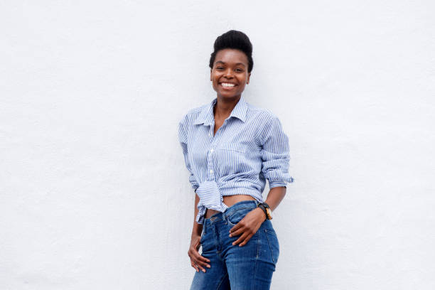 istock smiling young black woman leaning against white background 873393190