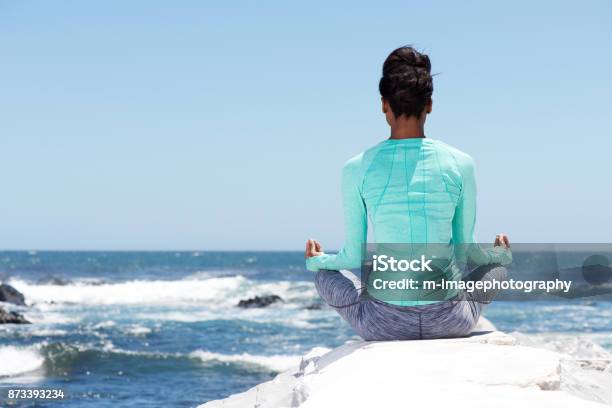 Behind Of Yoga Woman At The Beach Stock Photo - Download Image Now - Beach, Meditating, Women