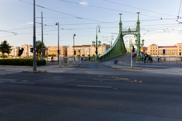 Liberty bridge in Budapest, Hungary. Liberty Bridge or Freedom Bridge in Budapest, Hungary, connects Buda and Pest across the River Danube. It is the third southernmost public road bridge in Budapest, located at the southern end of the City Centre. It was originally named Franz Joseph Bridge. At its two ends are two public squares, Gellert ter and Fovam ter.