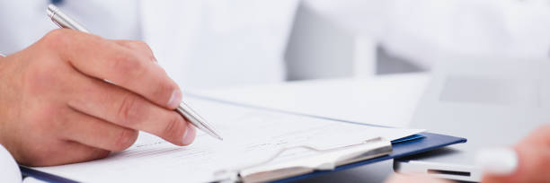 istock Male doctor arm hold silver pen 873396452