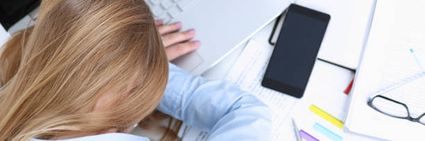 istock Tired businesswoman at workspace in office 873396756