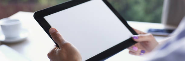 istock Businessman holding tablet in hand in cafe 873396958