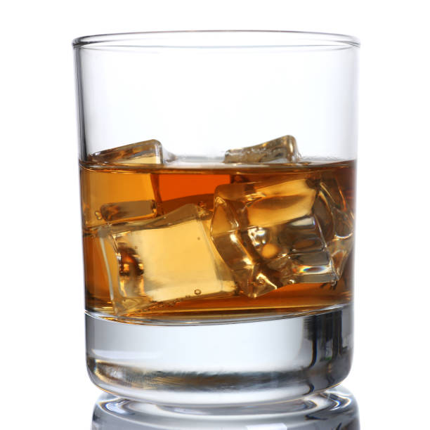 istock Whiskey with ice in a glass isolated 873397396