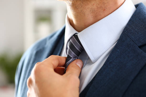 istock Male arm in blue suit set tie closeup 873397528
