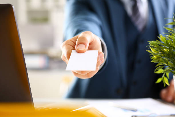 istock Male arm in suit give blank calling card 873397560