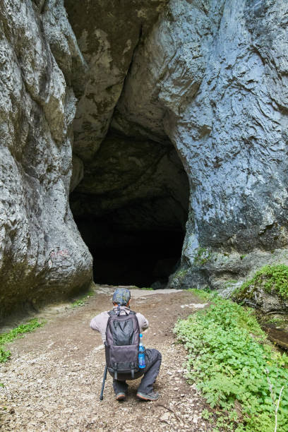 istock Nature photographer shooting in a cave 873397594