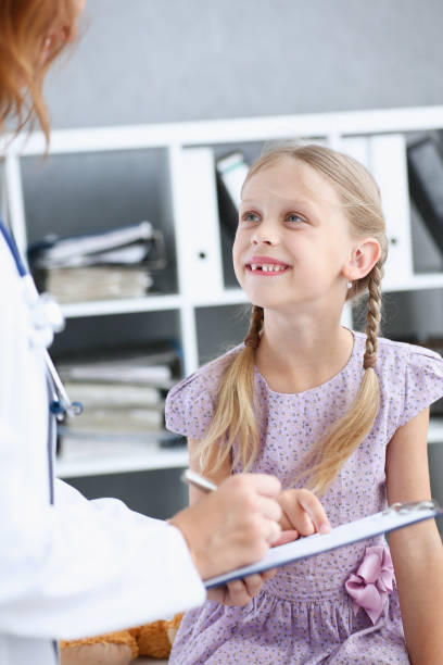 istock Little child at pediatrician reception 873397716
