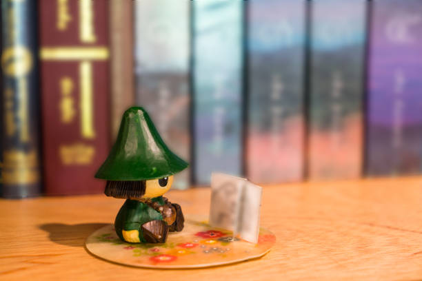 istock Reading Doll in book cabinet 873403300