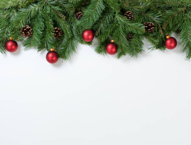 istock Christmas red ornaments hanging in fir tree branches 873403440