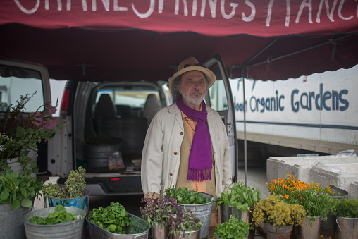 San Francisco, USA - August 4, 2015: People selling and buying flowers at organic farmers market in San Francisco