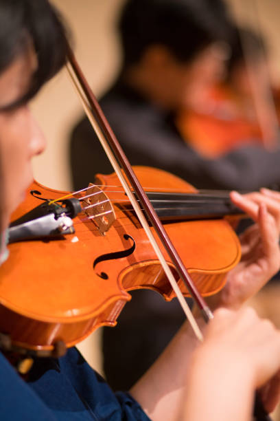 istock woman playing in violin in concert 873409284