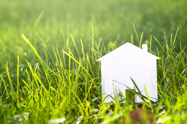 istock Conceptual Paper House on Grass 873409678