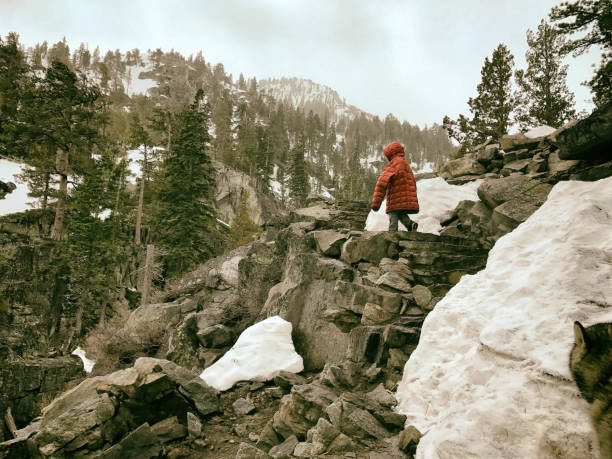 istock Young boy hiking in his father's coat up a steep trail 873409730