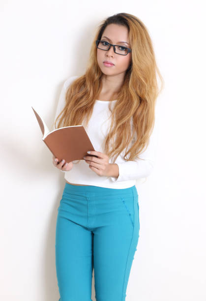 young asian woman in white shirt holding her book for work