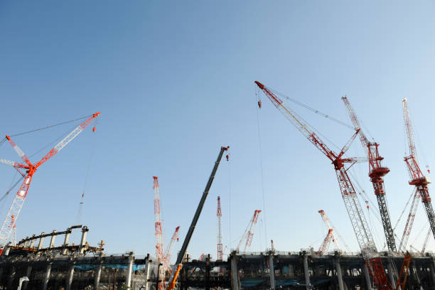 istock Many crane of construction site against clear sky with copy space 873415736