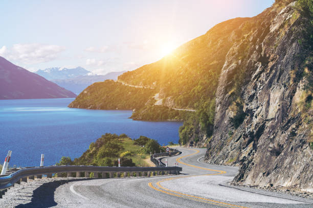 istock Winding Road along Mountain Cliff and Lake 873418896