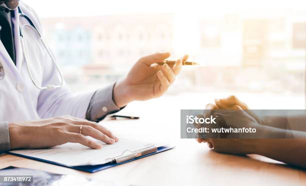 Doctor Hand Holding Pen And Talking To The Patient About Medication And Treatment Stock Photo - Download Image Now