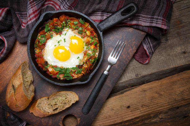 istock Country style fried eggs with vegetable salsa and parsley 873423042