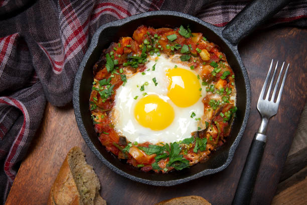 istock Country style fried eggs with vegetable salsa and parsley 873423046