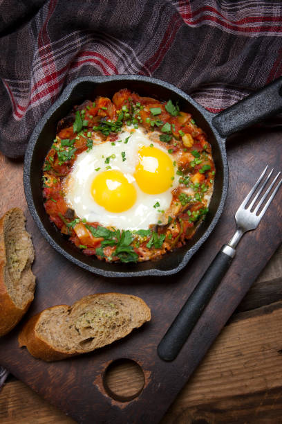 istock Country style fried eggs with vegetable salsa and parsley 873423098