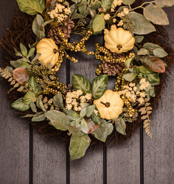 istock Thanksgiving wreath with pumpkins hanging on front door 873423394