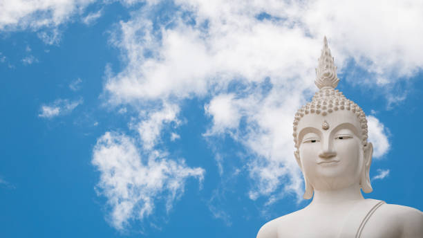 istock Old buddha statue on Clouds and blue sky background. 873434846