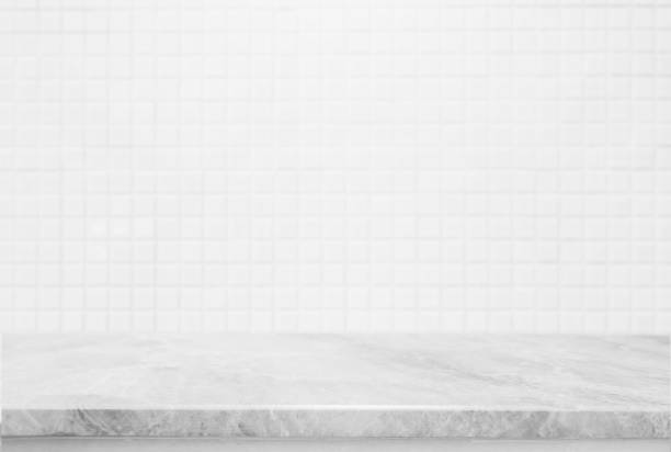 istock Stone marble table top and background of white ceramic tile wall - can used for display or montage your products. 873441166