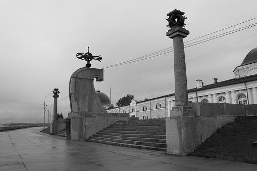 Embankment of river Nothern Dvina, Arkhangelsk, Russia with Pur Navolok monument black and white